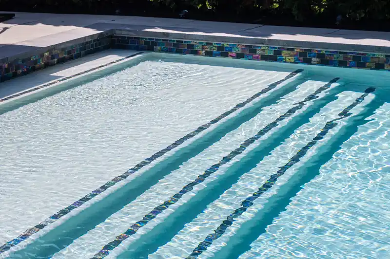 Tiled entry steps leading down into clear pool water