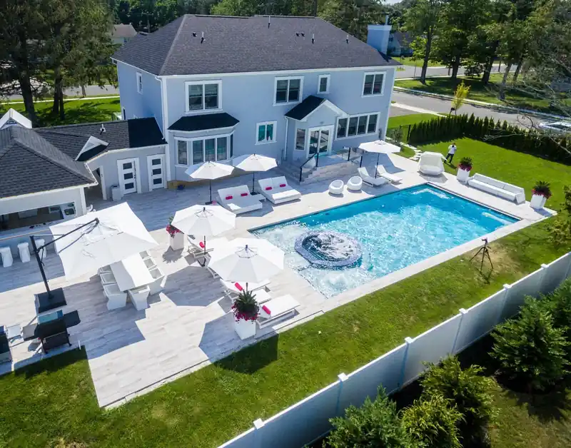 Aerial view of a house, pool and loungers